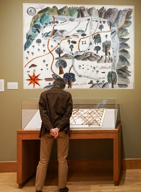 A visitor looks at maps on display