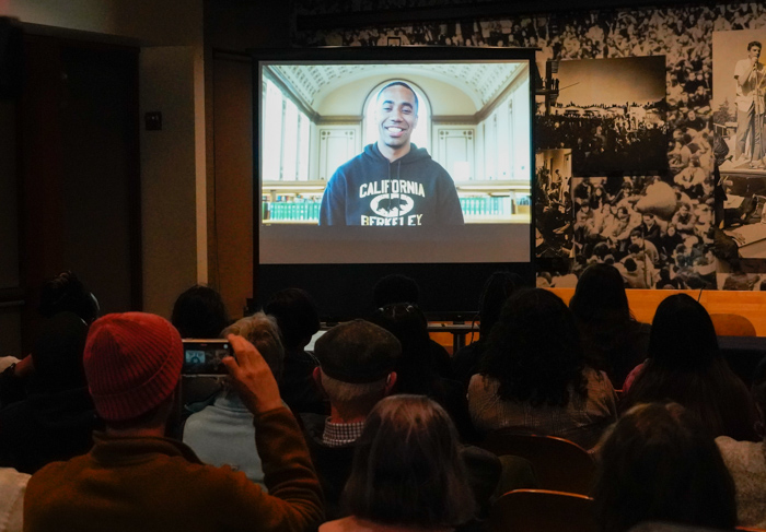 Guests watch the film “From Incarceration to Education”