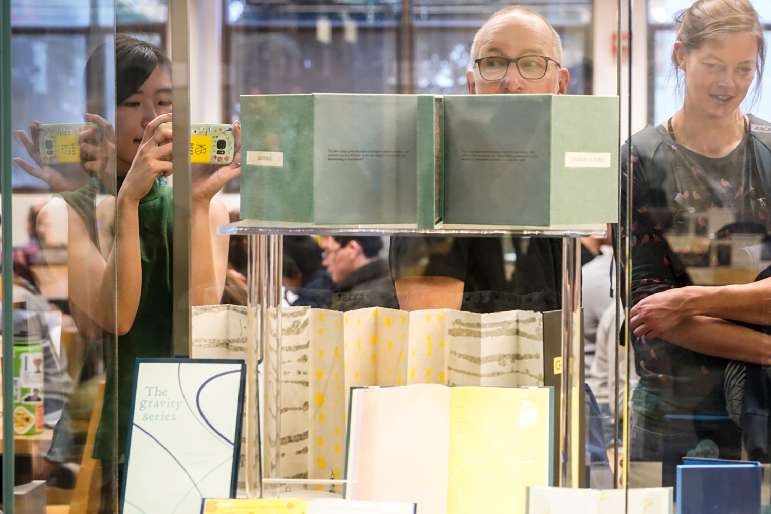 Attendees look at books on display