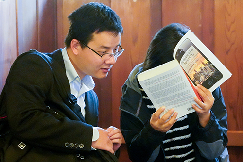 Guests look closely at a book