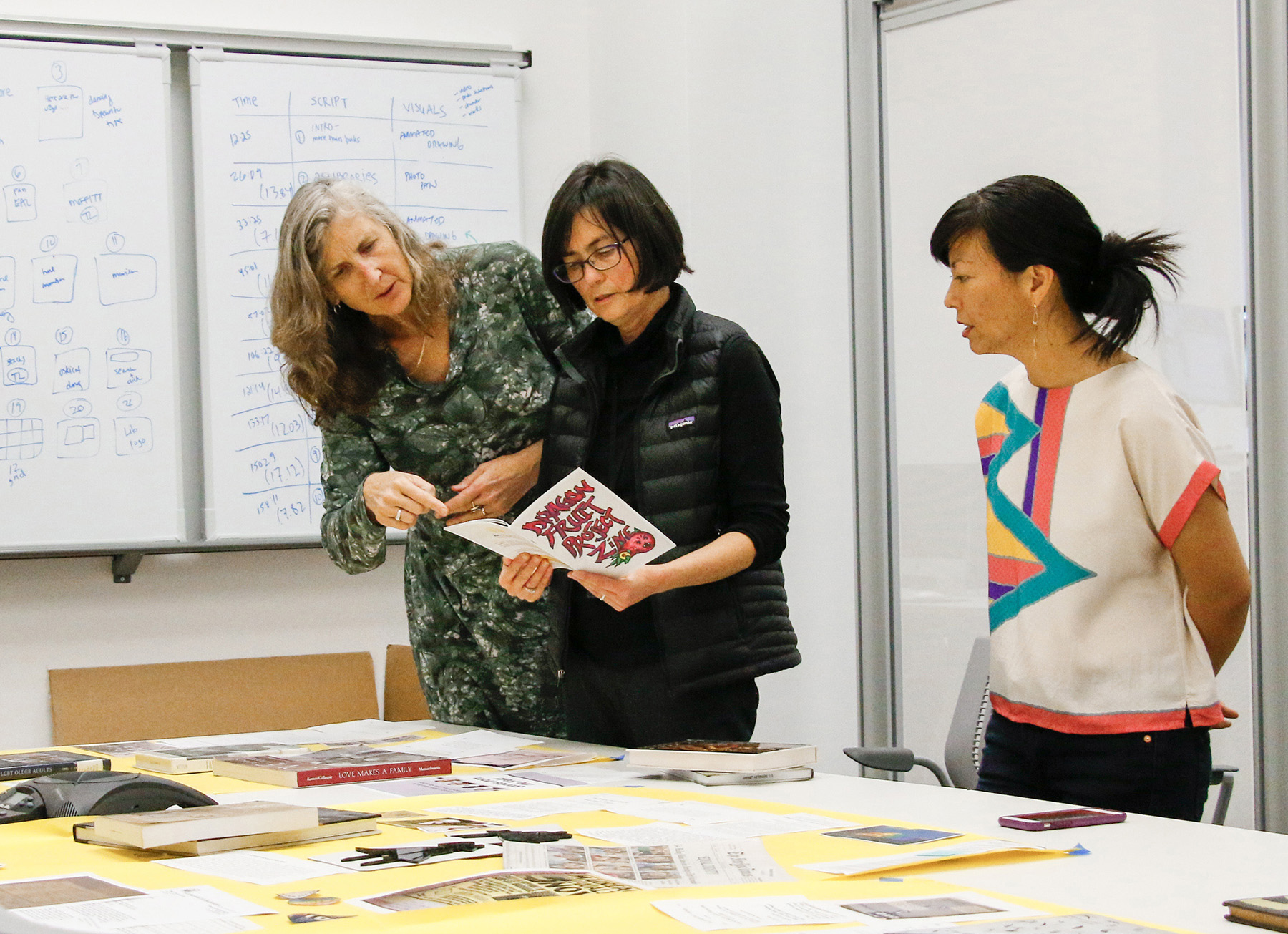 Curators select items for a new exhibit in Doe Library on the LGBTQ movement. (Photo by Jami Smith for the UC Berkeley Library)