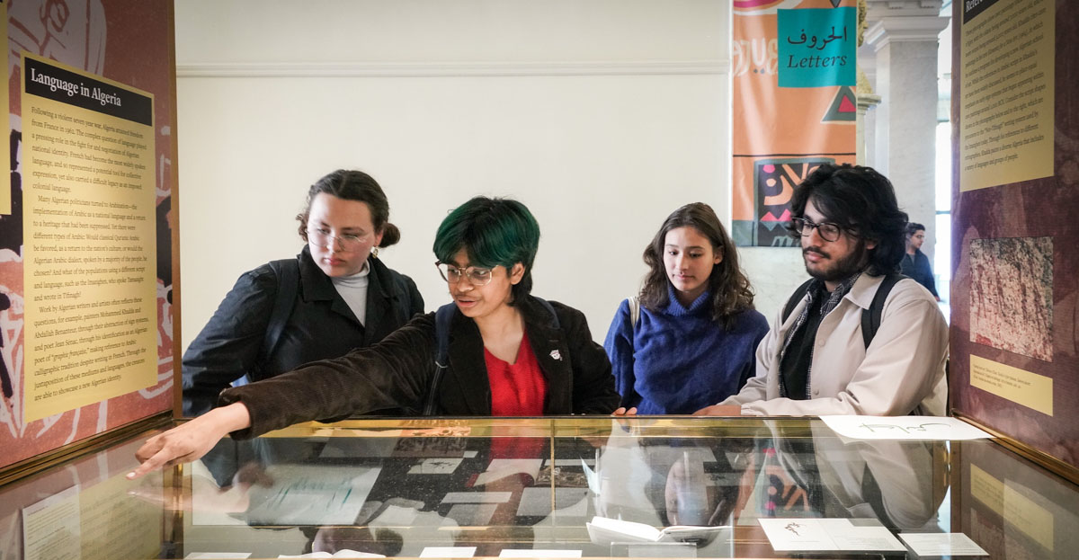 students look at an exhibit case