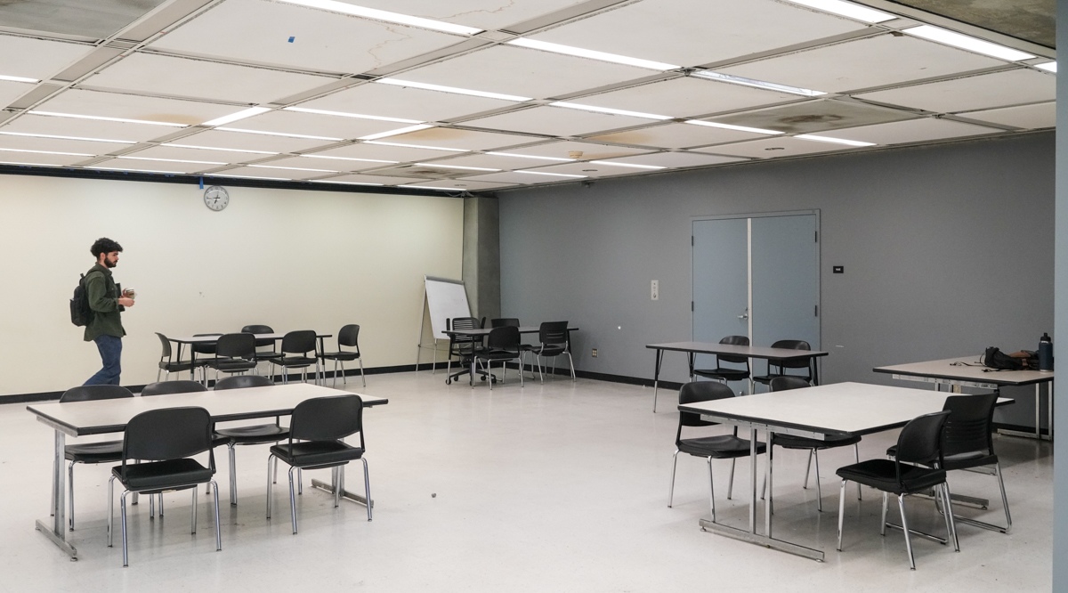 A student looks for a seat in an empty room in Moffitt  Library