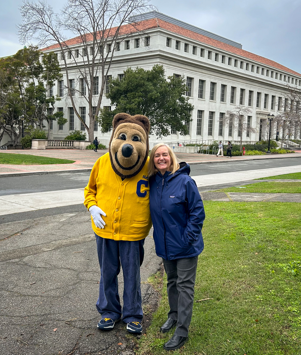 University Librarian Suzanne Wones poses for a photo with Oski outside Doe Library.