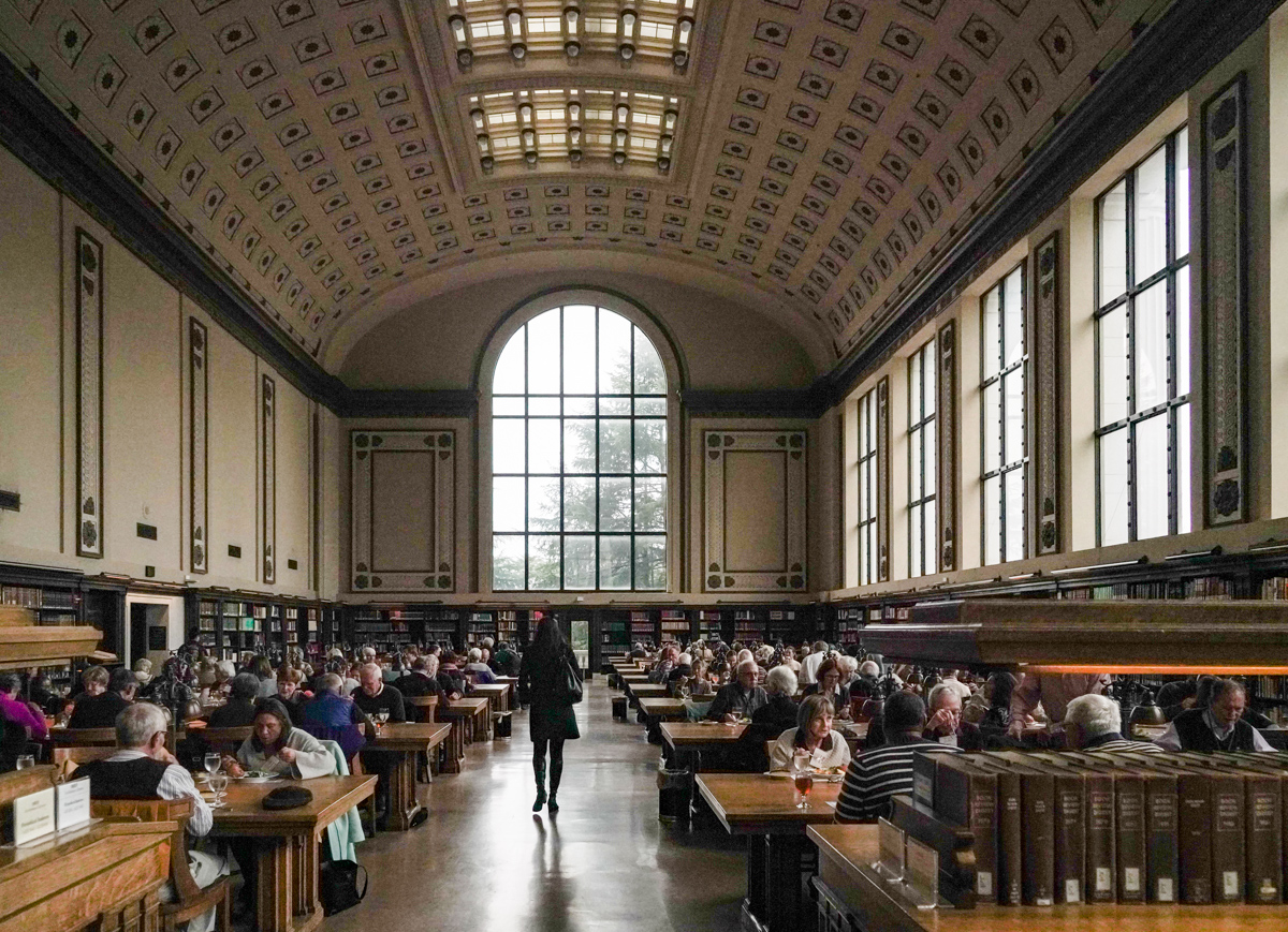 An attendee walks down the center aisle of the reading room